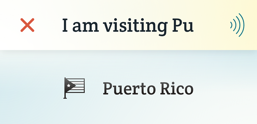 The phrase “I am visiting Pu...” is typed into Spoken. “Puerto Rico” is suggested below. A Puerto Rican flag icon is next to the prediction.