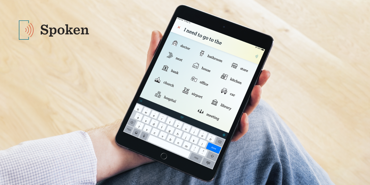 A closeup of someone holding an iPad with the Spoken AAC app on screen.